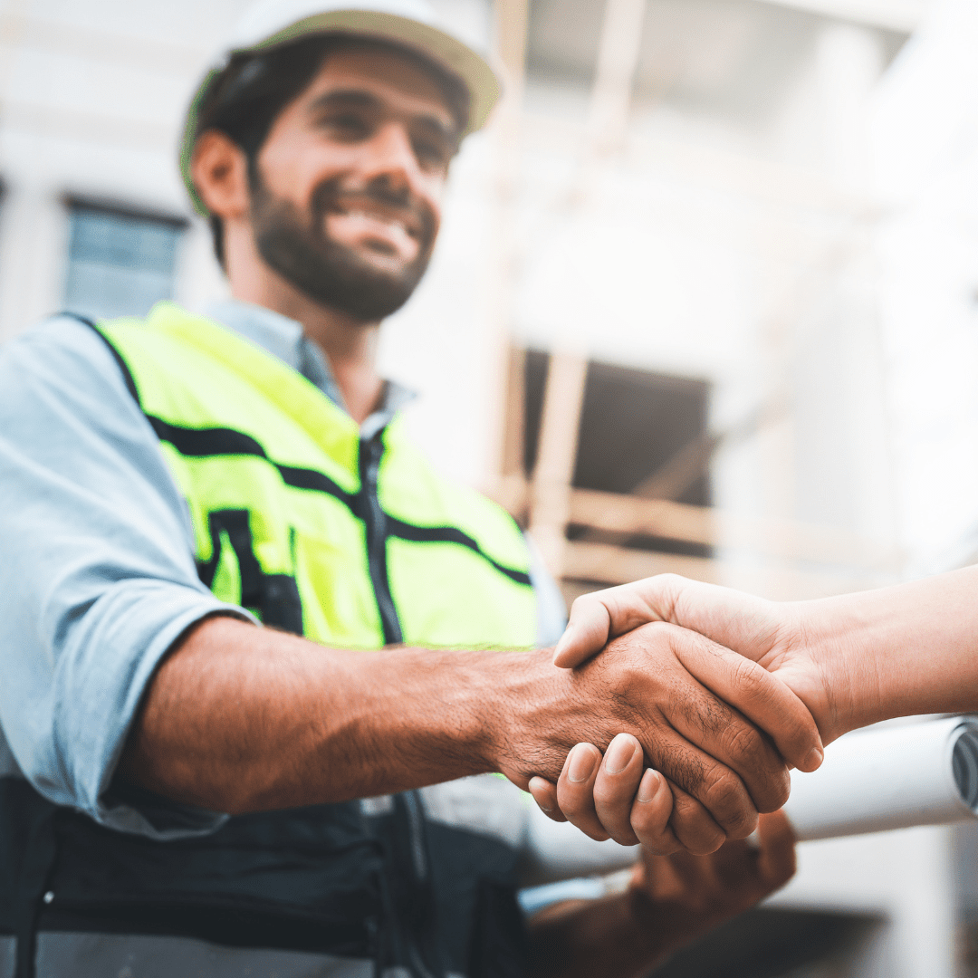 A temporary worker shaking hands with a potential employer at a networking event